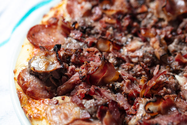 Tasty's Meat Lovers, plain with our own spicy pepperoni, 100% ground beef, Montreal’s famous smoked meat and bacon